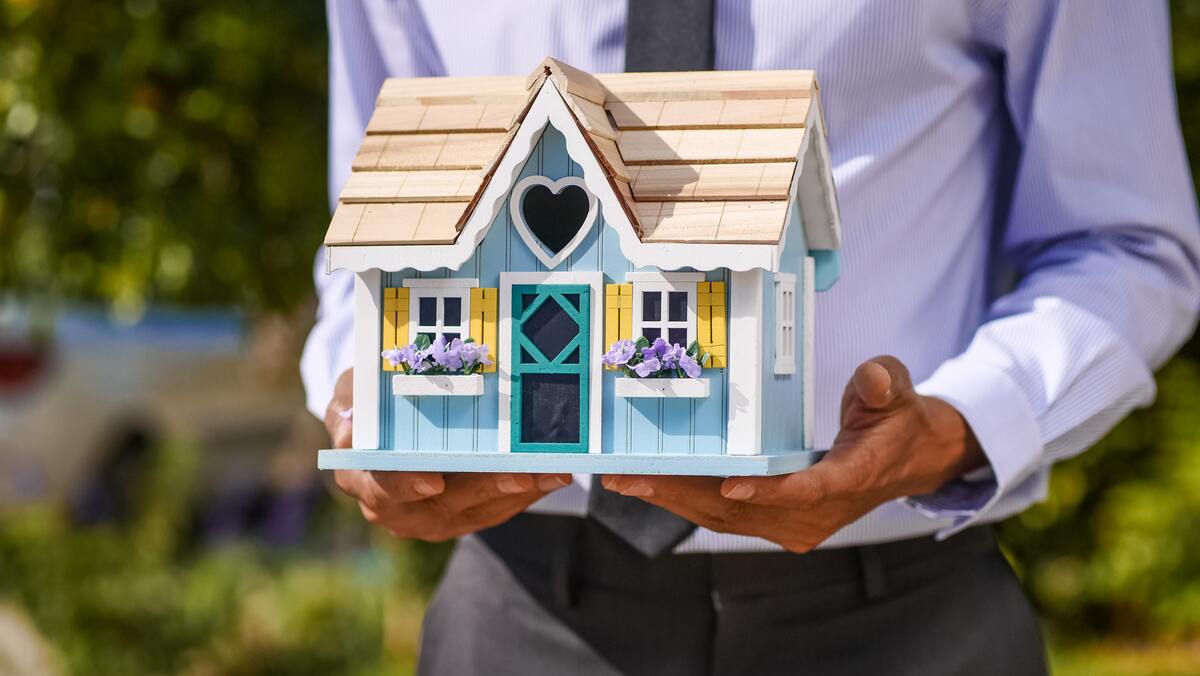 hombre con una casa en las manos